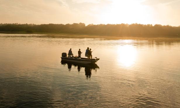A boat with people fishing at Reed Bingham State Park in Adel, Georgia
