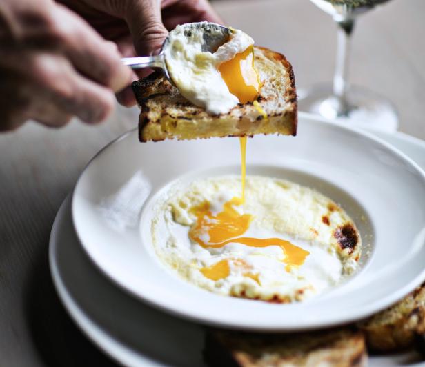 Egg on toast over a bowl of grits at Miller Union in Atlanta, Georgia