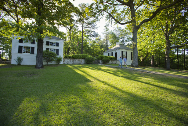 A field of green grass slopes away from the Little White House in Warm Springs, Georgia