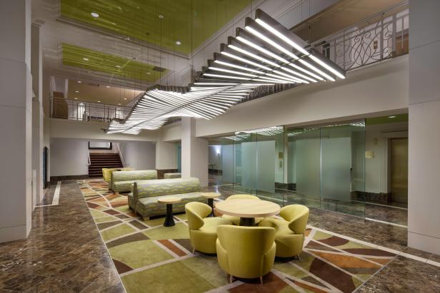 An open hotel lobby with colorful decor and lights