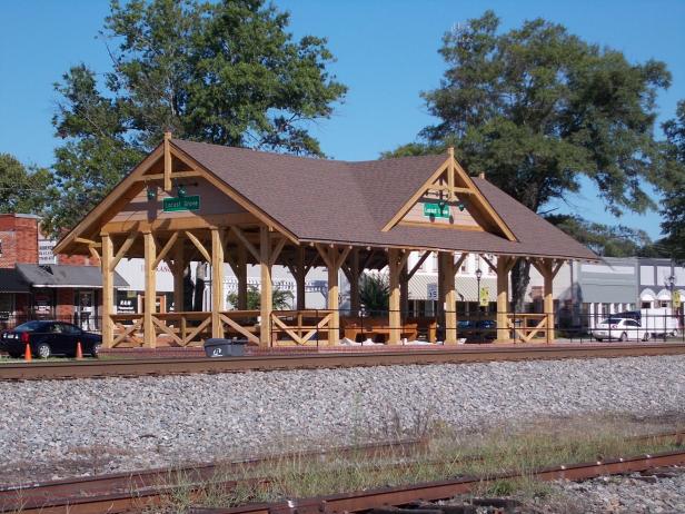 A viewing platform sits along train tracks.