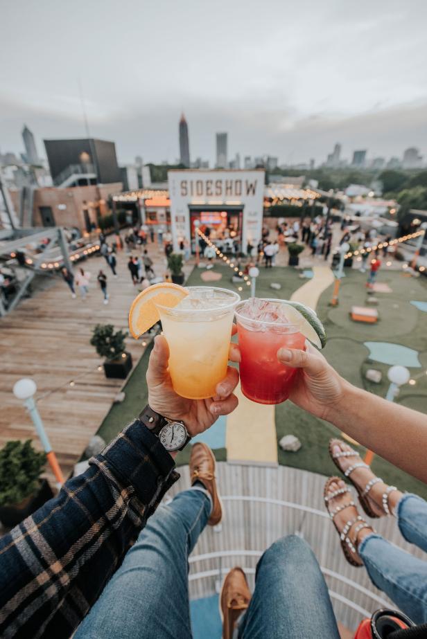 Couple with cocktails at Skyline Park at Ponce City Market in Atlanta, Georgia