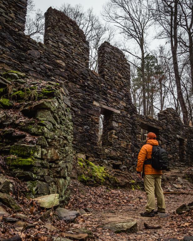 Hiker admiring the paper mill ruins on the Sope Creek Trail in Marietta. Photo by @westy4xer