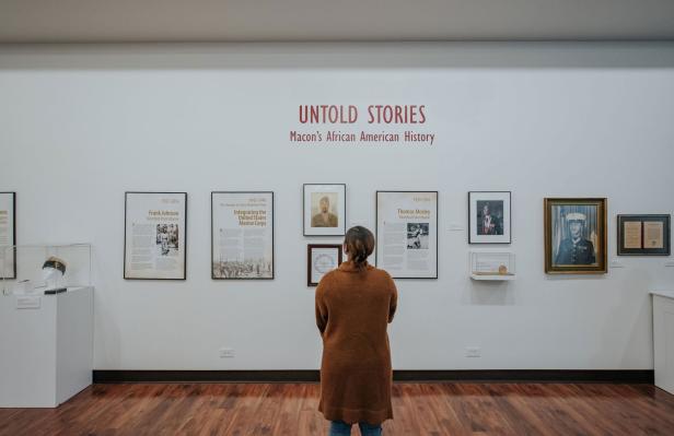 Woman looking at Untold Stories exhibit at the Tubman Museum in Macon, Georgia