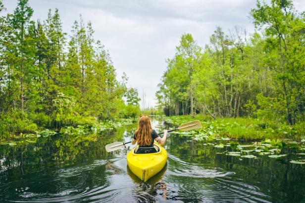 Woman kayaking in the Okefenokee Swamp. Photo by @wandernorthga