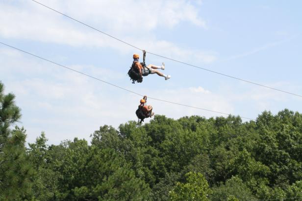 Two people ziplining at Banning Mills