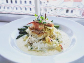 Pan seared wreck fish over infused risotto with lobster and saffron cream sauce
