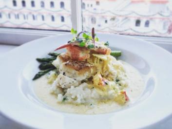 Pan seared wreck fish over infused risotto with lobster and saffron cream sauce