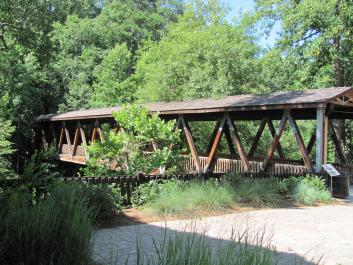 The covered pedestrian bridge is enjoyed by photographers and hikers.