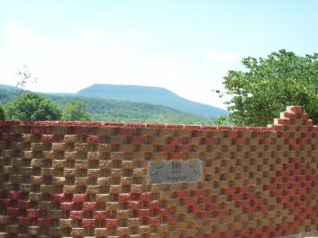 Entrance wall to driveway with Atwood Mtn. in background