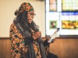 An attendee of the reader's theatre at historic First African Baptist Church reads from a card during the performance.