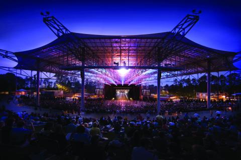 Ameris Bank Amphitheater at night with purple lights 