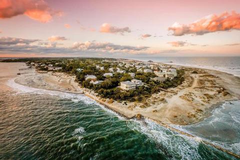 Aerial view of a town on an island surrounded by beaches.