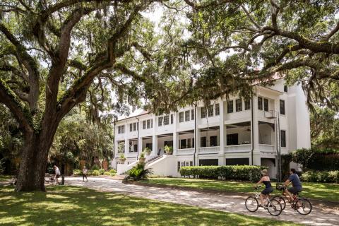 Cyclists riding in front of Greyfield Inn on Cumberland Island, Georgia