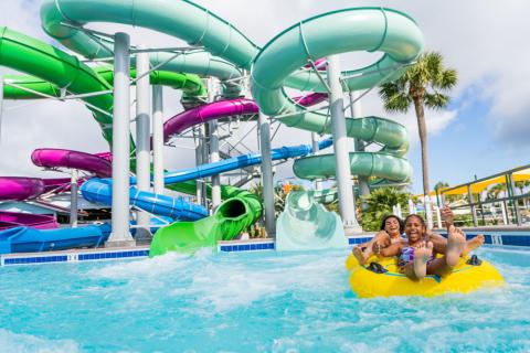 Guest splash around on a large water park slide