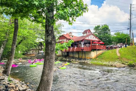 People on tubes float down the river in Helen, Georgia