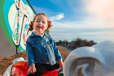 Child smiling in front of a mural in Tifton, Georgia
