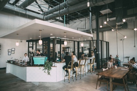 Interior of East Pole Coffee with people seated around the bar and at tables