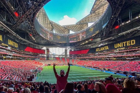 Crowd cheering at an Atlanta United soccer game in Mercedes-Benz Stadium in Atlanta, Georgia