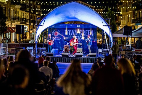 Band playing on the Town Green Stage at Wire & Wood Festival in Alpharetta, Georgia