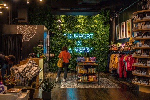 Support is a verb neon sign in Village Retail store in Atlanta, Georgia