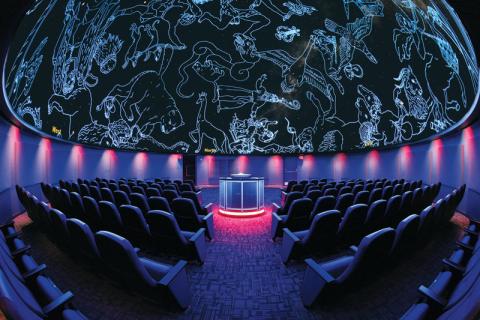 Seats inside a 360-degree planetarium theater