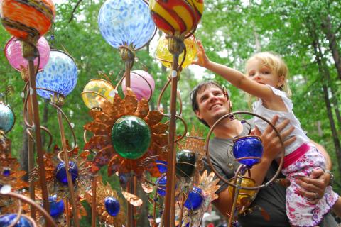 Father and child with art at the Yellow Daisy Festival at Stone Mountain Park