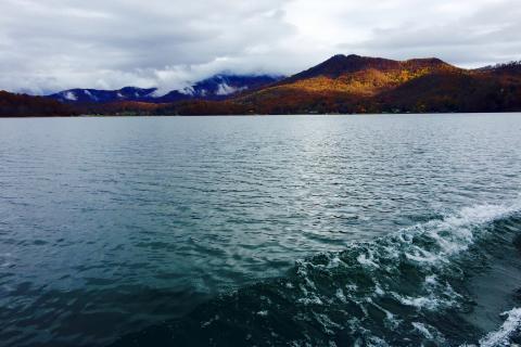 A lake with mountains in the background