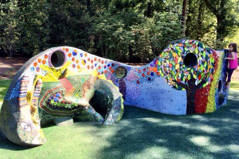 A large colorful painted sculpture in an outdoor playground