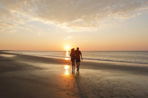 Couple walking on the beach on St. Simons Island, Georgia