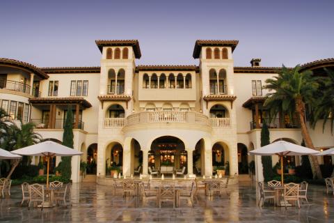 The entrance of a large luxury resort with ivory stonework.