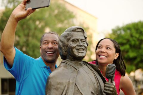 Couple with James Brown statue in Augusta, Georgia