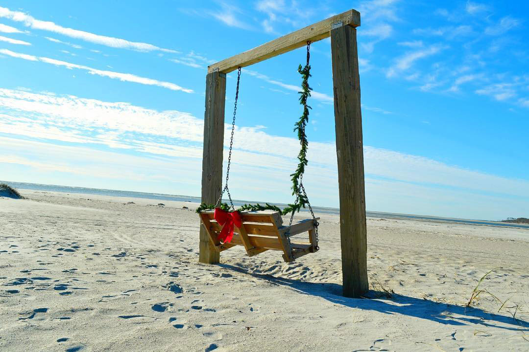 Swing on the beach decorated for the holidays on Tybee Island, Georgia. Photo by @visittybee