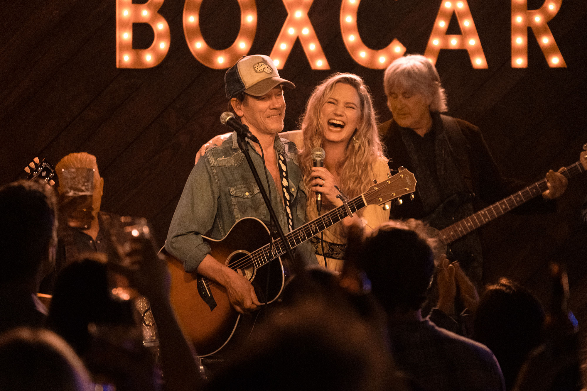 Kevin Bacon on stage with a guitar in a scene for The Bondsman, filmed in Grantville, Georgia