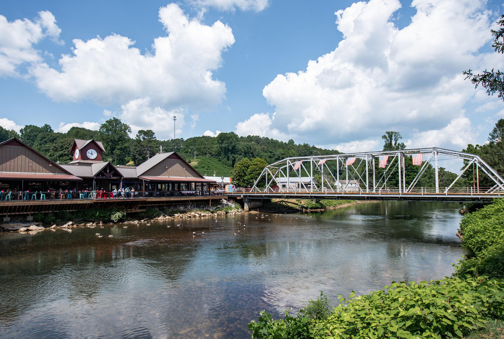 View of riverfront shops and bridge over Toccoa River in McCaysville, Georgia