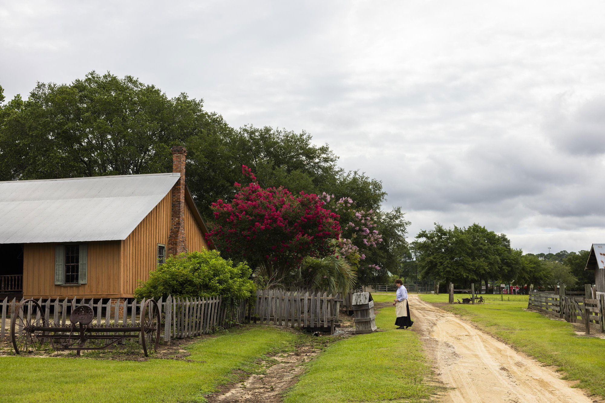 Woman working outside a farmhouse at ABAC's Georgia Museum of Agriculture in Tifton, Georgia